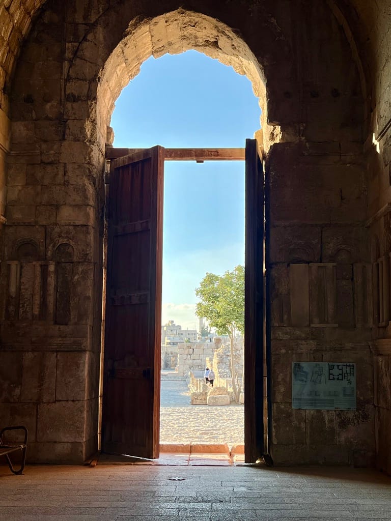 Light creeps in, thought the door of this citadel building