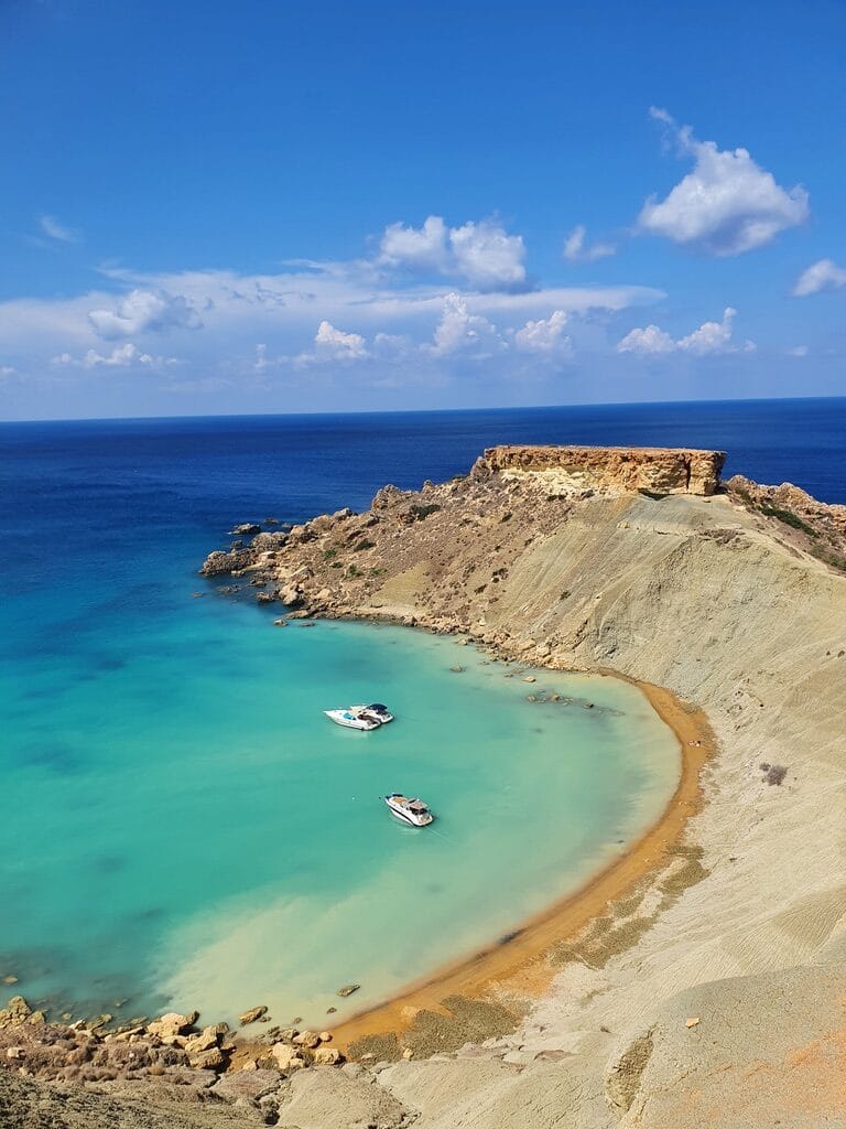 Hiking around crystal clear waters the West of Malta, a surprisingly affordable island to travel to