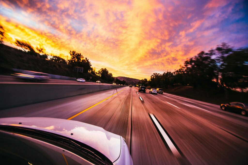 Travel with EV car at sunset on the highway